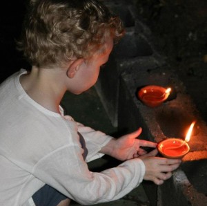 child placing candles