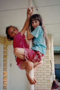 girls climbing a pole